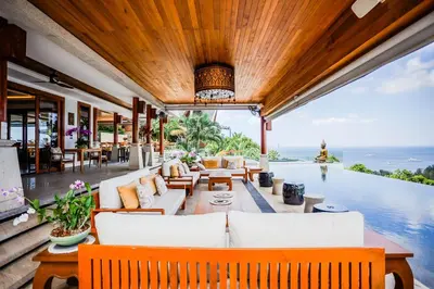 an outdoor living room with a view of the ocean at Villa Talay in Surin Beach