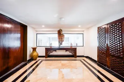 a room with a table and a vase on the floor at Villa Talay in Surin Beach