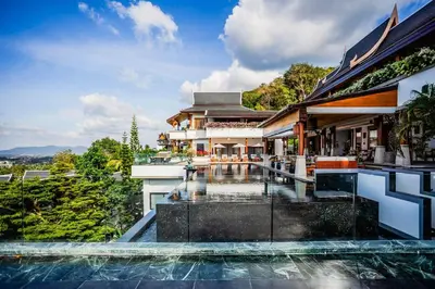 an exterior view of a house with a swimming pool at Villa Talay in Surin Beach