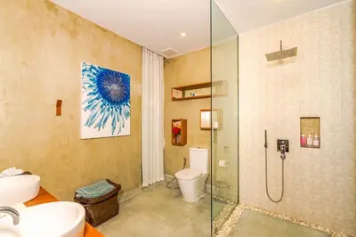 a bathroom with a toilet and a glass shower at Baan Klong II in Ko Yao Noi