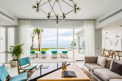 a living room with a couch and chairs at Baan Kloi II in Ban Na Tai
