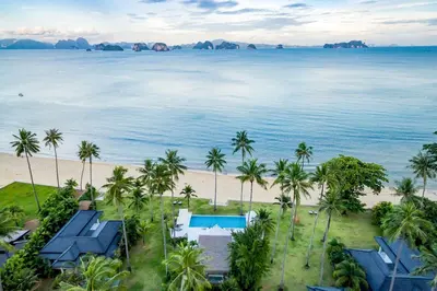 an aerial view of a beach with palm trees at Baan Klong IV in Ko Yao Noi