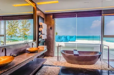 a bathroom with two sinks and a large window at Baan Kloi III in Ban Na Tai