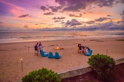 a group of people on the beach at sunset at Baan Kloi in Ban Na Tai