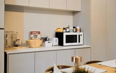 a microwave sitting on a counter in a kitchen at COMFORTABLE RENOVATED 2BR TownHouse5 MonkeyHill in Ban Sam Kong