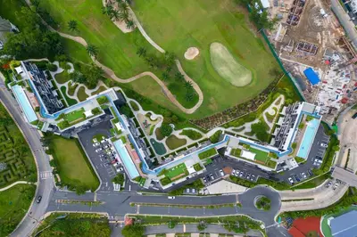 an overhead view of a building with a golf course at Fairway Escape - Golf View 1BR with Balcony in Laguna in Laguna Phuket