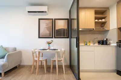 a small kitchen and dining room with a table and chairs at Fairway Escape - Golf View 1BR with Balcony in Laguna in Laguna Phuket