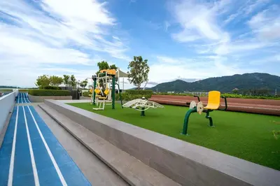 a playground with two chairs and a swing at Fairway Escape - Golf View 1BR with Balcony in Laguna in Laguna Phuket