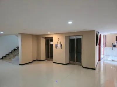 a room with a hallway with a staircase and a room with a unintention at 777 Beach Condotel in Mai Khao Beach