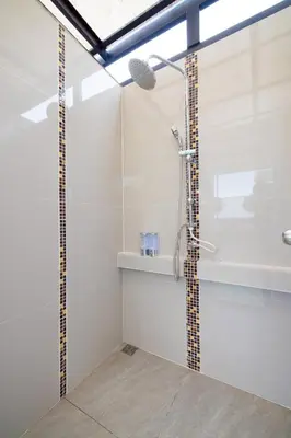 a bathroom with a shower with a microphone at 113 Yellow House Hostel in Phuket Town