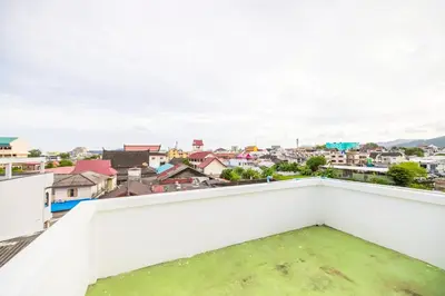 a view from the balcony of a city at 113 Yellow House Hostel in Phuket Town