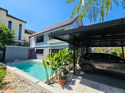 a car parked under a cover in front of a house at 2 Bedroom Pool Villa in Kamala in Kamala Beach