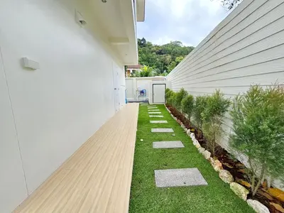 an internal courtyard of a house with green grass at 2 Bedroom Pool Villa Green View in Kamala Beach