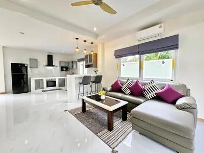 a living room with a couch and a table at 2 Bedroom Pool Villa Green View in Kamala Beach