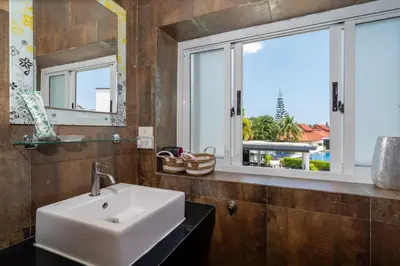 a bathroom with a sink and a window at Sunny Paradise Kamala Beach in Kamala Beach