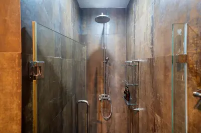 a bathroom with a shower with a glass door at Sunny Paradise Kamala Beach in Kamala Beach
