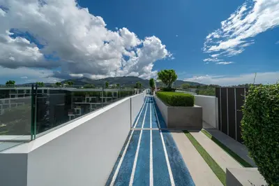 a walkway on the roof of a building at Skypark Laguna Garden View Bang Tao Beach in Laguna Phuket