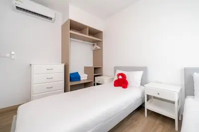 a bedroom with two beds and a red teddy bear on the bed at Skypark Laguna Bang Tao Beach in Laguna Phuket