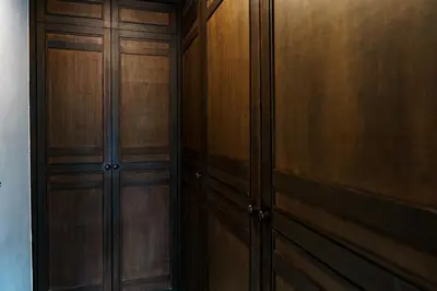 a wooden closet with wooden doors in a room at Noksawan Villa by G Estate in Rawai Beach