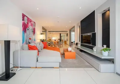 a living room with a white couch and a television at JSD Prime Property-Surin Beach in Surin Beach