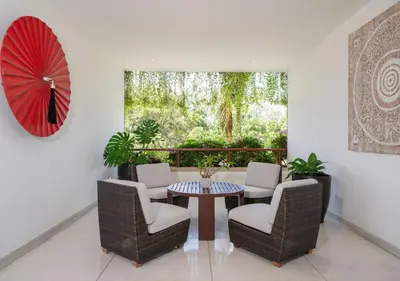 a room with a table and chairs and a large window at JSD Prime Property-Surin Beach in Surin Beach