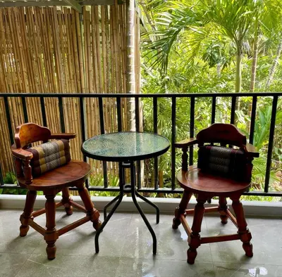 two chairs and a table and a table and two chairs at Jampun Pool Villa in Klong Muang Beach