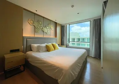 a bedroom with a large bed and a large window at Luxurious 5-star Apartment in Rawai Beach