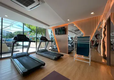 a gym with two treadmills and a treadmill at Luxurious 5-star Apartment in Rawai Beach