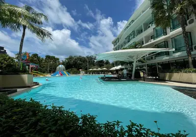 a large swimming pool next to a building at Luxurious 5-star Apartment in Rawai Beach