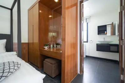 a bathroom with a bed and a sink in a room at Wings Villa Laguna Bang Tao Beach Phuket in Ban Pak Lak