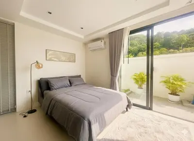 a bedroom with a bed and a large window at Mali Thai Villa - Just 5 minutes to Kata Beach in Kata Beach