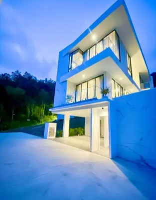 a large white house with a lot of windows at Mali Thai Villa - Just 5 minutes to Kata Beach in Kata Beach