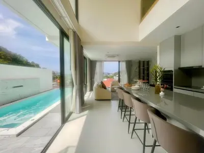 a kitchen and living room with a swimming pool at Mali Thai Villa - Just 5 minutes to Kata Beach in Kata Beach