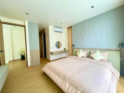 a bedroom with a large bed and a mirror at Mali Thai Villa - Just 5 minutes to Kata Beach in Kata Beach