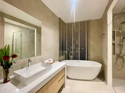 a bathroom with a white tub and a sink and a bath tub at Mali Thai Villa - Just 5 minutes to Kata Beach in Kata Beach
