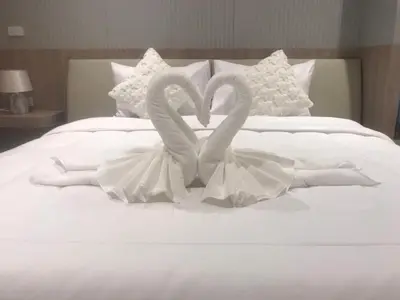 two swans making a heart shape on a bed at Mali Thai Villa - Just 5 minutes to Kata Beach in Kata Beach
