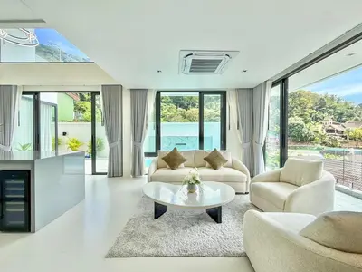 a living room with two couches and a table at Mali Thai Villa - Just 5 minutes to Kata Beach in Kata Beach