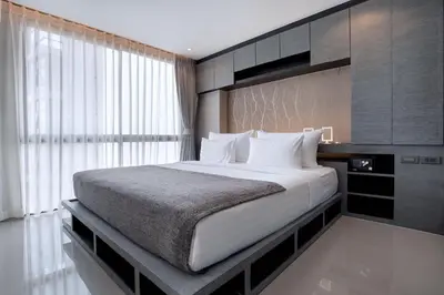 a bedroom with a large bed and a large window at Tropics Kamala Hill View Apartment CTG D704 near Beach and Fantasea in Kamala Beach