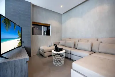 a living room with a couch and a flat screen tv at Fun, Beach & Topical Vibes! Pool View 2BR Apartment CTG P603-4 in Tropics Kamala Residence in Kamala Beach