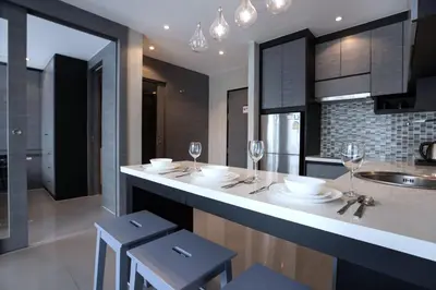 a kitchen with a counter with wine glasses on it at Fun, Beach & Topical Vibes! Pool View 2BR Apartment CTG P603-4 in Tropics Kamala Residence in Kamala Beach