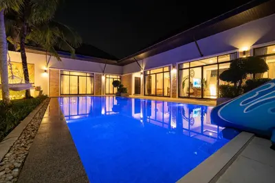 a large swimming pool with blue lighting in a house at Bua Sawan - 4 Bedrooms Pool Villa in Ban Pak Lak