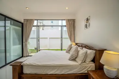 a bedroom with a bed and a large window at Bua Sawan - 4 Bedrooms Pool Villa in Ban Pak Lak