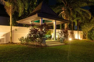 a house with a gazebo in the yard at night at Bua Sawan - 4 Bedrooms Pool Villa in Ban Pak Lak