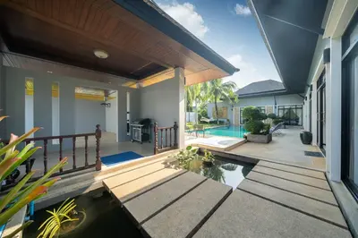 a house with a swimming pool and a patio at Bua Sawan - 4 Bedrooms Pool Villa in Ban Pak Lak