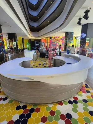 a lobby with a circular counter in a mall at Cassia Loft Laguna Phuket Bang Tao Beach in Laguna Phuket
