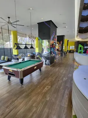 a billiard room with a pool table and a room with at Cassia Loft Laguna Phuket Bang Tao Beach in Laguna Phuket