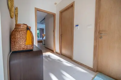 a hallway with a basket sitting on a wooden table at Villa Allamanda 3 Bdrm Best Location Bangtao Beach VVPHU88 in Phuket