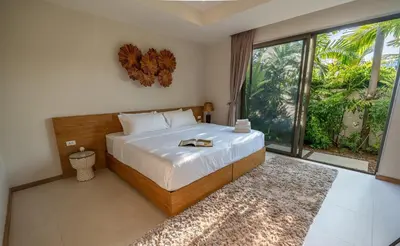 a bedroom with a large bed and a large window at Villa Allamanda 3 Bdrm Best Location Bangtao Beach VVPHU88 in Phuket
