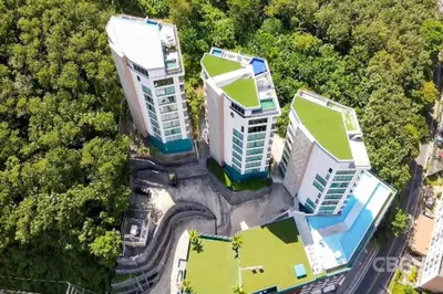 an overhead view of three tall buildings in a forest at Prime Location Kamala Ocean View Suite OCN C64 just 450m to the Beach in Kamala Beach