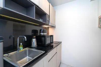 a kitchen with a sink and a microwave at Prime Location Kamala Ocean View Suite OCN C64 just 450m to the Beach in Kamala Beach